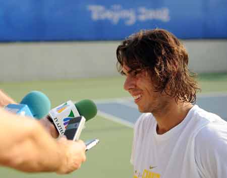 Spanish tennis player Rafael Nadal receives interview after a training session at the Beijing Olympic Green Tennis Court in Beijing, China, Aug. 5, 2008. 