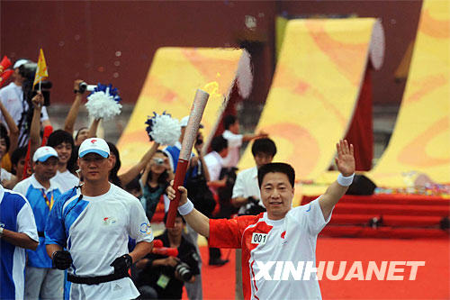 Yang Liwei runs with the Olympic torch in Beijing on August 6.