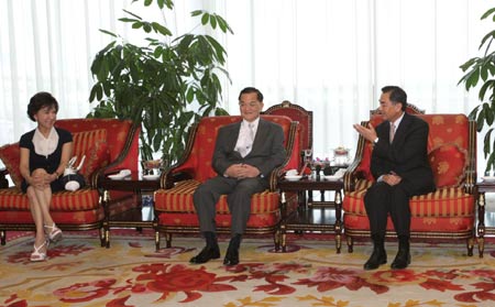 Lien Chan (C), honorary chairman of the Chinese Nationalist Party, or Kuomintang (KMT), and his wife Lien Fang-yu are welcomed by Wang Yi (R), director of both the Taiwan Work Office of the Communist Party of China (CPC) Central Committee and the State Council's Taiwan Affairs Office, in Beijing, capital of China, Aug. 5, 2008. Lien Chan and his wife Lien Fang-yu arrived in Beijing on Tuesday to attend the opening ceremony of Beijing Olympic Games slated for Aug. 8. (Xinhua/Wang Yongji)