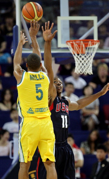 Mills from Australia making a jump shot despite Howard&apos;s block [CFP]