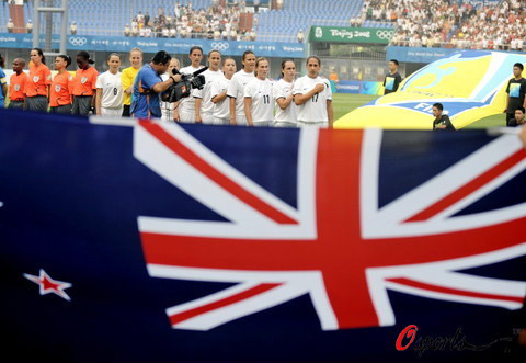 New Zealand national flag and Olympic team in the first round of Olympic women football game in Qinhuangdao, north China's Hebei Province on August 6, 2008.