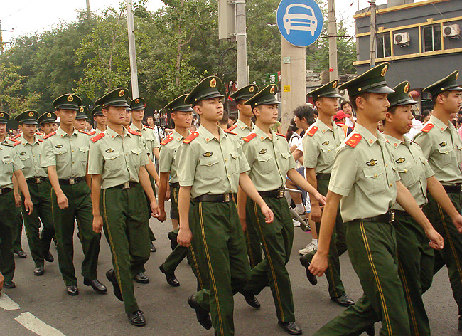 Armed police were employed to maintain order and ensure security as tens of thousands of people rushed to Baiguang Street in Xuanwu District to watch the Olympic torch relay in downtown Beijing. [China.org.cn] 