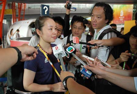 Chinese Hong Kong table tennis player Tie Ya Na speaks to the media at the Beijing Capital International Airport in Beijing