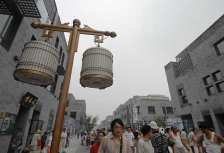 Pedestrians walk on the newly-renovated Qianmen Street in central Beijing, China, Aug. 7, 2008. [Jin Liangkuai/Xinhua] 