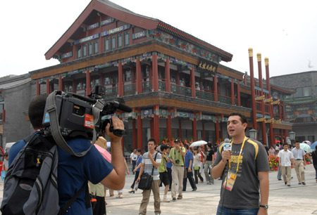 Foreign TV reporters shoot their documentary on the newly-renovated Qianmen Street in central Beijing, China, Aug. 7, 2008.[Jin Liangkuai/Xinhua]