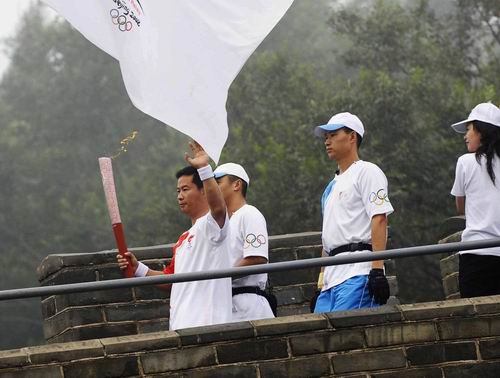 Torchbearer Li Longjiang carries the Olympic torch on the Great Wall in Beijing August 7.