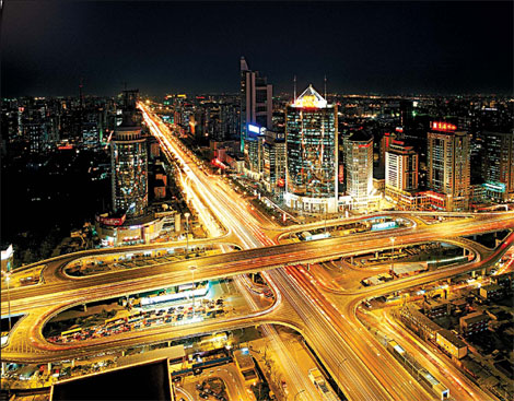 A view of the Beijing CBD at night, featuring landmark buildings and multiple forms of transport. [China Daily]