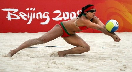 US world and olympic champion Misty May-Treanor dives for the ball during a practice session at Beijing's Chaoyang Park Beach volleyball ground on August 7, 2008, on the eve of the opening of the 2008 Beijing Olympic Games. America and Brazil, two nations blessed with more sand and sun than most, will resume their battle for beach volleyball domination in Beijing after virtually monopolising gold in previous editions. [China Daily/Agencies]