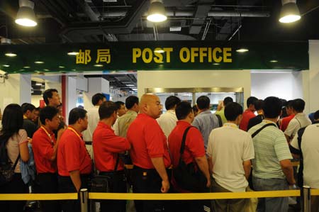 People wait in line to buy the first day cover (FDC) at the post office of the Main Press Center (MPC) in the Olympic Green in Beijing, China, at about 8 a.m. on Aug. 8, 2008, 12-hour countdown to the opening ceremony of the Olympics. The opening ceremony of the Beijing 2008 Olympic Games will be held in the National Stadium at 8 p.m. on Aug. 8.[Xinhua]