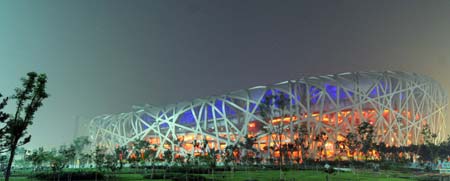 Photo taken at around 04:00 on Aug. 8, 2008 shows the National Stadium, namely the Bird&apos;s Nest, being illuminated in Beijing, China, 16-hour countdown to the opening ceremony of the Olympics. The opening ceremony of the Beijing 2008 Olympic Games will be held in the National Stadium at 8 p.m. on Aug. 8. [Xinhua]