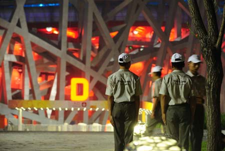 Security guards shift their duty near the National Stadium, namely the Bird&apos;s Nest, at about 02:00 on Aug. 8, 2008 in Beijing, China, 18-hour countdown to the opening ceremony of the Olympics. The opening ceremony of the Beijing 2008 Olympic Games will be held in the Bird&apos;s Nest at 8 p.m. on Aug. 8.[Xinhua]