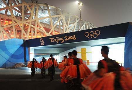 Working members walk into the National Stadium, namely the Bird&apos;s Nest, at about 01:00 on Aug. 8, 2008 in Beijing, China, 19-hour countdown to the opening ceremony of the Olympics. The opening ceremony of the Beijing 2008 Olympic Games will be held in the Bird&apos;s Nest at 8 p.m. on Aug. 8.[Xinhua]