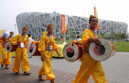 Waist drummers prepare to enter the National Stadium, known as the Bird's Nest, in Beijing, China, Aug. 8, 2008, about 3-hour countdown to the opening ceremony of the Olympics by press time. The opening ceremony of the Beijing 2008 Olympic Games will be held in the National Stadium at 8:00 p.m. on Aug. 8. (Xinhua/Zhang Ling)