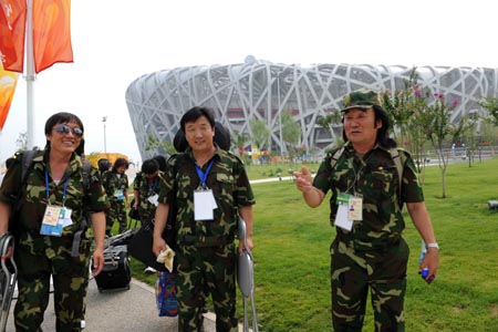 Famous horse-head fiddle player Qi Baoligao (R) prepares to enter the National Stadium, known as the Bird's Nest, in Beijing, China, Aug. 8, 2008, about 3-hour countdown to the opening ceremony of the Olympics by press time. The opening ceremony of the Beijing 2008 Olympic Games will be held in the National Stadium at 8:00 p.m. on Aug. 8. (Xinhua/Zhang Ling)
