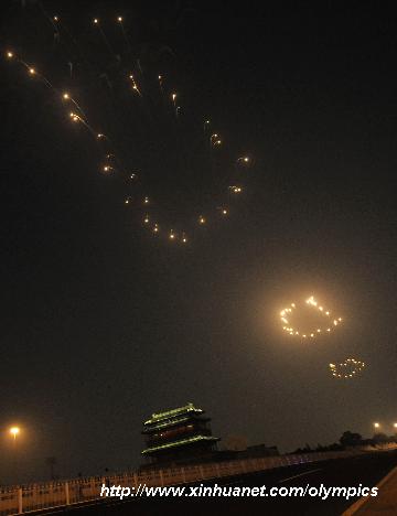 Photo taken on Aug. 8, 2008 shows the fireworks named the 'Footprints of History', symbolizing the pace of the successive summer Games, in the sky during the opening ceremony of the Beijing Olympic Games held in the National Stadium, also known as the Bird's Nest, in Beijing, China. [Wang Qingxin/Xinhua]