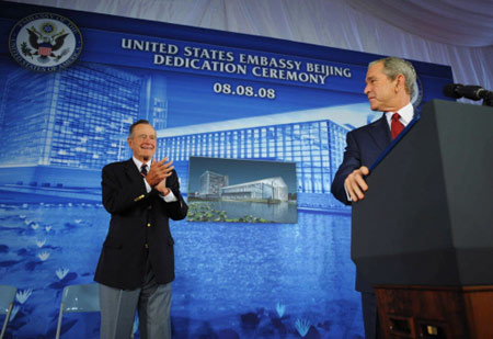 Former US president George H. W. Bush (L) applauds his son, US President George W. Bush, during the dedication ceremony of the new US embassy on August 8, 2008 in Beijing.