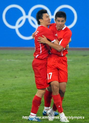 Dong Fangzhuo (R) of China celebrates with his teammate after a goal during the Beijing Olympic Games men's football Group C first round match against New Zealand at Shenyang Olympic Stadium.
