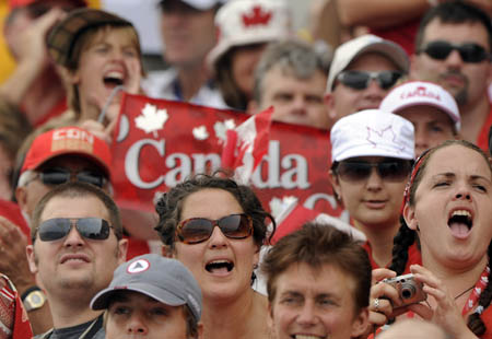 Canadian people cheer for their rowers during the rowing competition at Beijing 2008 Olympic Games in Shunyi Olympic Rowing-Canoeing Park in Beijing, China, Aug. 9, 2008. The Olympic rowing competition started on Saturday. (Xinhua/Guo Lei)