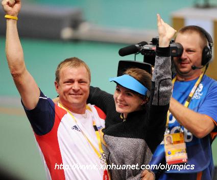 Markswoman Katerina Emmons (C) of Czech celebrates with her coach after women's 10m Air rifle final of Beijing Olympic Games at Beijing Shooting Range Hall in Beijing, China, Aug. 9, 2008. [Xinhua] 