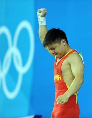 Long Qingquan of China celebrates after taking a successful snatch lift at the men's 56kg final of weightlifting at Beijing 2008 Olympic Games in Beijing, China, Aug. 10, 2008. Long claimed title in this event.[Xinhua]