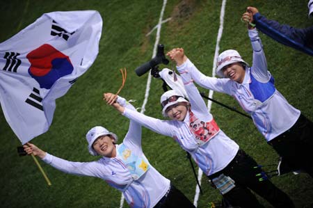 South Korea athletes celebrate after wining the gold of the women's team final of archery at Beijing 2008 Olympic Games in Beijing, China, Aug. 10, 2008. South Korea defeated China and claimed the title in this event.