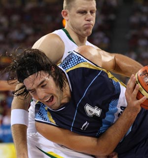 Luis Alberto Scola (front), forward of Argentina passes the ball during Men's Preliminary Round Group A game 10 between Argentina and Lithuania of Beijing 2008 Olympic Games basketball event at the Beijing Olympic Basketball Gymnasium in Beijing, China, Aug. 10, 2008. Lithuania beat Argentina 79-75. (Xinhua/Meng Yongmin)