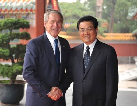 Chinese President Hu Jintao (R) shakes hands with US President George W. Bush at Zhongnanhai, compound of China's central authorities, in Beijing, China, Aug. 10, 2008. [Xinhua]