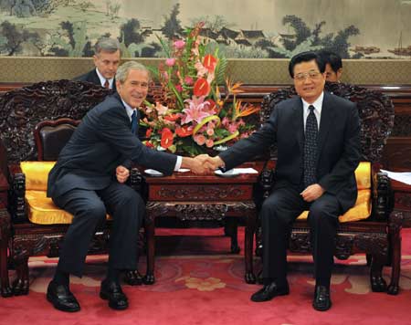 Chinese President Hu Jintao (R, front) shakes hands with U.S. President George W. Bush during their meeting at Zhongnanhai, compound of China's central authorities, in Beijing, China, Aug. 10, 2008. [Xinhua]