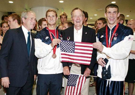 US president Goerge W. Bushes and his father Bush Sr. pose for photo with Michael Phelps and Ryan Lochte after the top swimmers won the gold and bronze medal respectively in the 400m medley final. Phelps also shattered the world with a with 4 minutes 3.84 seconds finish.