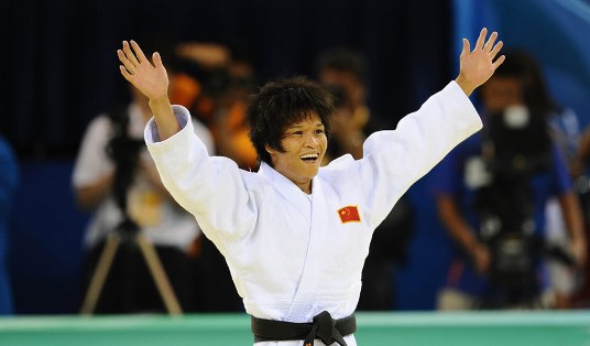 Xian Dongmei of China celebrates after defeating An Kum Ae of the Democratic People’s Republic of Korea during the women -52 kg final of judo at the Beijing Olympics in Beijing, China, Aug. 10, 2008. Xian Dongmei gained the gold medal of the event.