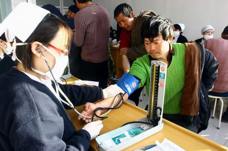 A worker receives free health examination in Beijing