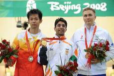Gold medalist Abhinav Bindra of India (C), the runner-up Zhu Qinan of China (L) and bronze winner Henri Hakkinen of Finland pose for pictures on podium during awarding ceremony of men's 10m air rifle final of Beijing Olympic Games at Beijing Shooting Range Hall in Beijing, China, Aug. 11, 2008. [Jiao Weiping/Xinhua] 