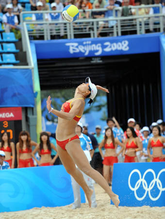 Tian Jia of China serves during the match against Liesbeth Mouha and Liesbet van Breedam of Belgium in women's preliminary pool A of the Beijing 2008 Olympic Games beach volleyball event in Beijing, China, Aug. 11, 2008. Wang Jie and Tian Jia of China won the match 2-1. (Xinhua/Sadat)