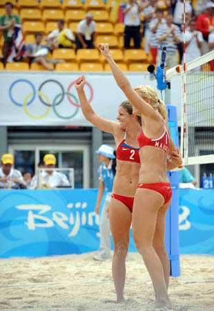 Kathrine Maaseide (R) and Susanne Glesnes of Norway celebrate after the women's preliminary pool A of the Beijing 2008 Olympic Games beach volleyball event against Simone Kuhn and Lea Schwer of Switzerland in Beijing, China, Aug. 11, 2008. Kathrine Maaseide and Susanne Glesnes of Norway won the match 2-0. (Xinhua/Sadat)
