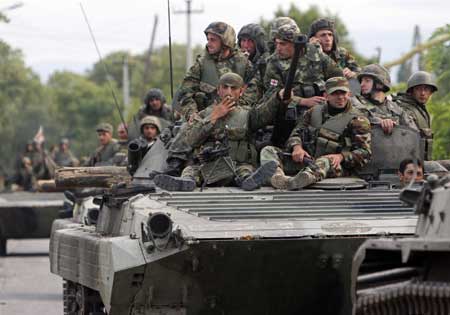 Georgian soldiers sit on a tank moving near the town of Tskhinvali, some 100 km (62 miles) from Tbilisi, Aug. 10, 2008. (Xinhua/Reuters Photo)