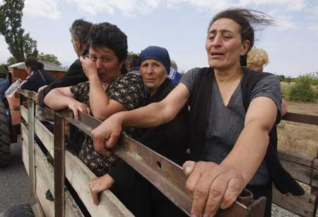 Georgian women cry as they leave their village near the town of Tskhinvali, some 100km (62 miles) from Tbilisi, Aug. 10, 2008