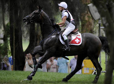Swiss rider Tiziana Realini rides her horse Gamour during eventing cross country competition at Hong Kong Olympic Equestrian Venue (Beas River) in the Olympic co-host city of Hong Kong, south China, Aug. 11, 2008. (Xinhua/Lui Siu Wai)