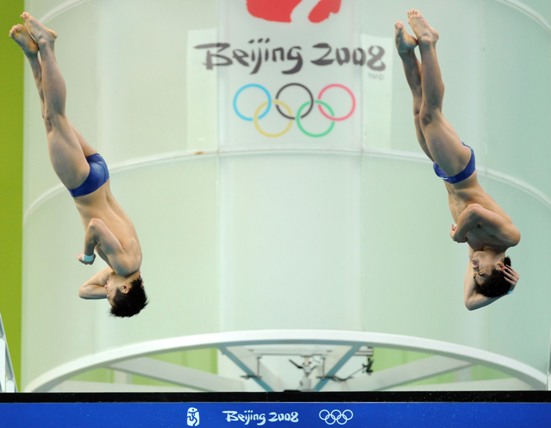 Chinese teenager divers Lin Yue and Huo Liang pose on the podium at the awarding ceremony of the men&apos;s 10-meter platform synchronized diving at the Beijing 2008 Olympic Games in the National Aquatics Center, also known as the Water Cube in Beijing, China, Aug. 11, 2008. Chinese team won the gold medal in the event with a score of 468.18 points.