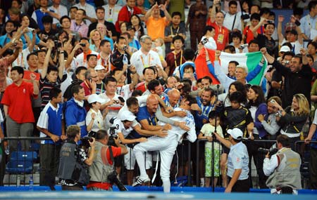 Matteo Tagliariol of Italy celebrates his victory over Fabrice Jeannet of France during men's individual epee final of Beijing 2008 Olympic Games fencing event at Fencing Hall of National Convention Center in Beijing, China, Aug. 10, 2008.