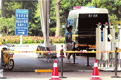 Vehicles transporting athletes'  urine samples are accompanied by armed guards as they make deliveries at the Olympic drug testing center. 