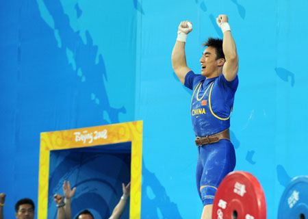 Liao Hui of China celebrates after taking a successful lift during the men's 69kg final of weightlifting at Beijing 2008 Olympic Games in Beijing, China, Aug. 12, 2008. Liao won the gold medal with a total of 348 kilos.