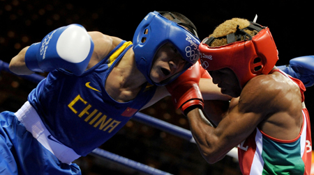 Li Yang (L) of China delivers a punch during Men's Feather (57kg) round of 32 between Brazil's Conceisao Robson and China's Li Yang of Beijing 2008 Olympic Games boxing event at Workers' Gymnasium in Beijing, China, Aug. 11, 2008. Li Yang beat Conceisao Robson 12-4.  