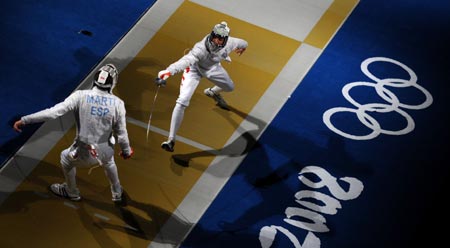 Zhong Man (R) of China attacks against Jaime Marti of Spain during their match at the men's individual sabre round of 16 of the Beijing 2008 Olympic Games fencing event at the Fencing Hall of National Convention Center in Beijing, Aug 12, 2008.[Xinhua] 