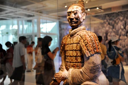 A Terracotta Warrior is displayed at an exhibiting center in the Olympic Green in Beijing, China, Aug. 11, 2008. Five genuine Terracotta Warriors and Horses, transported from Xi'an, capital of northwest China's Shaanxi Province, are displayed at the center, making it a place for foreign coaches, athletes and tourists to learn Chinese culture. [Li Ziheng/Xinhua]