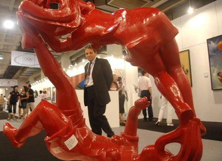 A visitor views a sculpture displayed at the China International Exhibition Center in Beijing, capital of China, Aug. 11, 2008. The Olympic Fine Arts 2008, held by the International Olympic Committee (IOC), opened in Beijing Monday, displaying more than 800 works selected from about 10,000 works of more than 40 countries and regions. [Xinhua]
