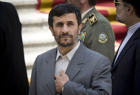 Iranian President Mahmoud Ahmadinejad looks on as he waits for his Algerian counterpart Abdelaziz Bouteflika in Tehran Aug. 11, 2008. Ahmadinejad vowed Monday that Tehran will never give up its nuclear program despite the risk of fresh sanctions, the state-run TV's website reported.