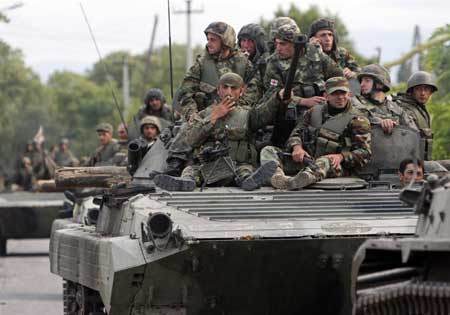 Georgian soldiers sit on a tank moving near the town of Tskhinvali, some 100 km (62 miles) from Tbilisi, Aug. 10, 2008. (Xinhua/Reuters Photo) 
