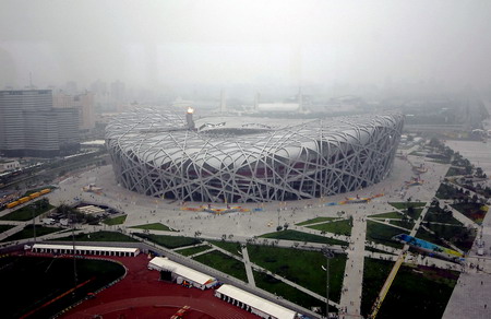 The National Stadium, or Bird's Nest, is seen in the rain from a window of International Broadcast Center (IBC) August 10 2008. [Xinhua]