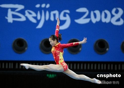Cheng Fei, the 2006 triple world title winner and three-time world champion on the vault, performs on the beam in the women's team qualification.