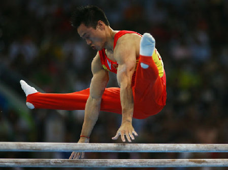 Yang Wei performs in the Olympic men's gymnastics team competition. 